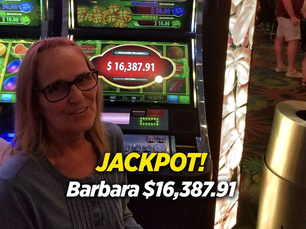 A woman standing in front of a slot machine with the words jackpot barbara.