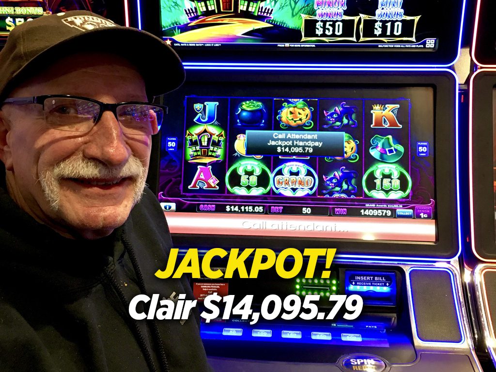 A man standing in front of a slot machine with the words jackpot.