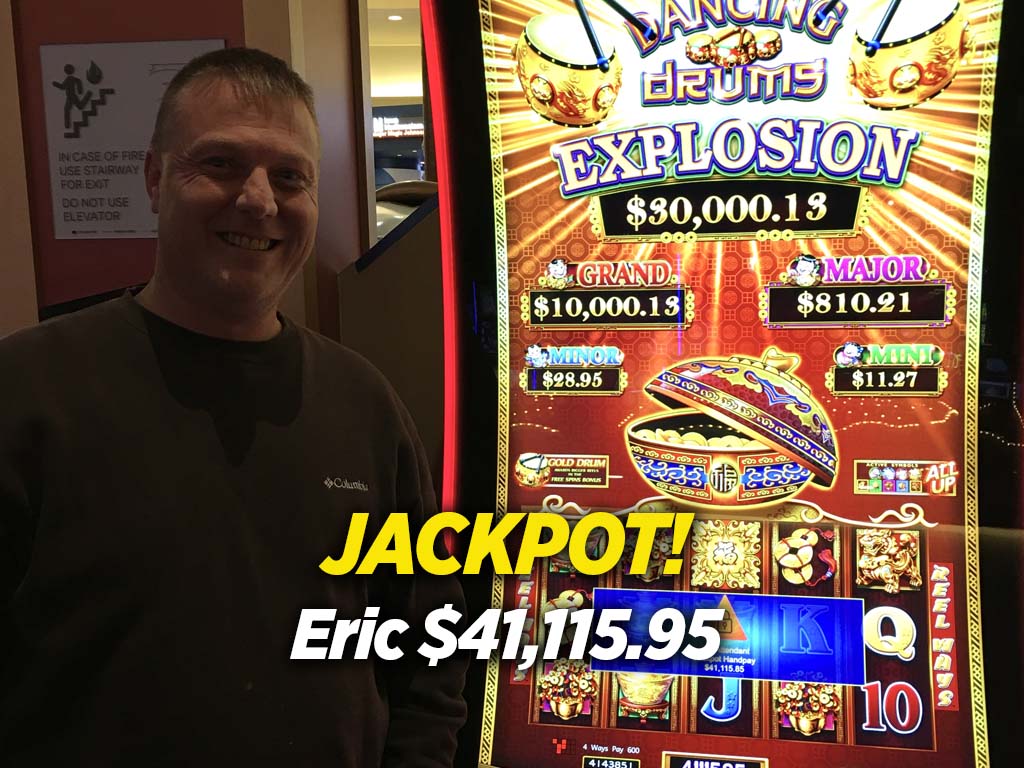A man standing in front of a jackpot machine.