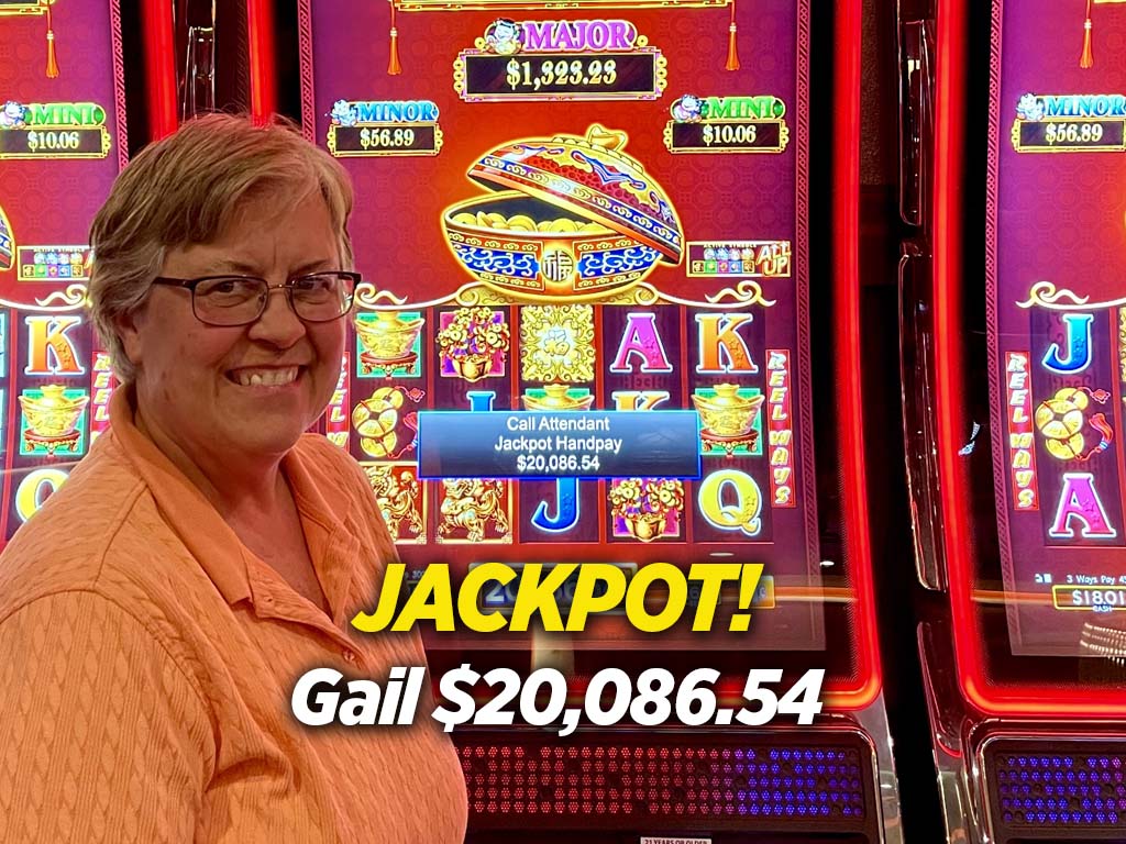A woman standing in front of a slot machine with the words jackpot.