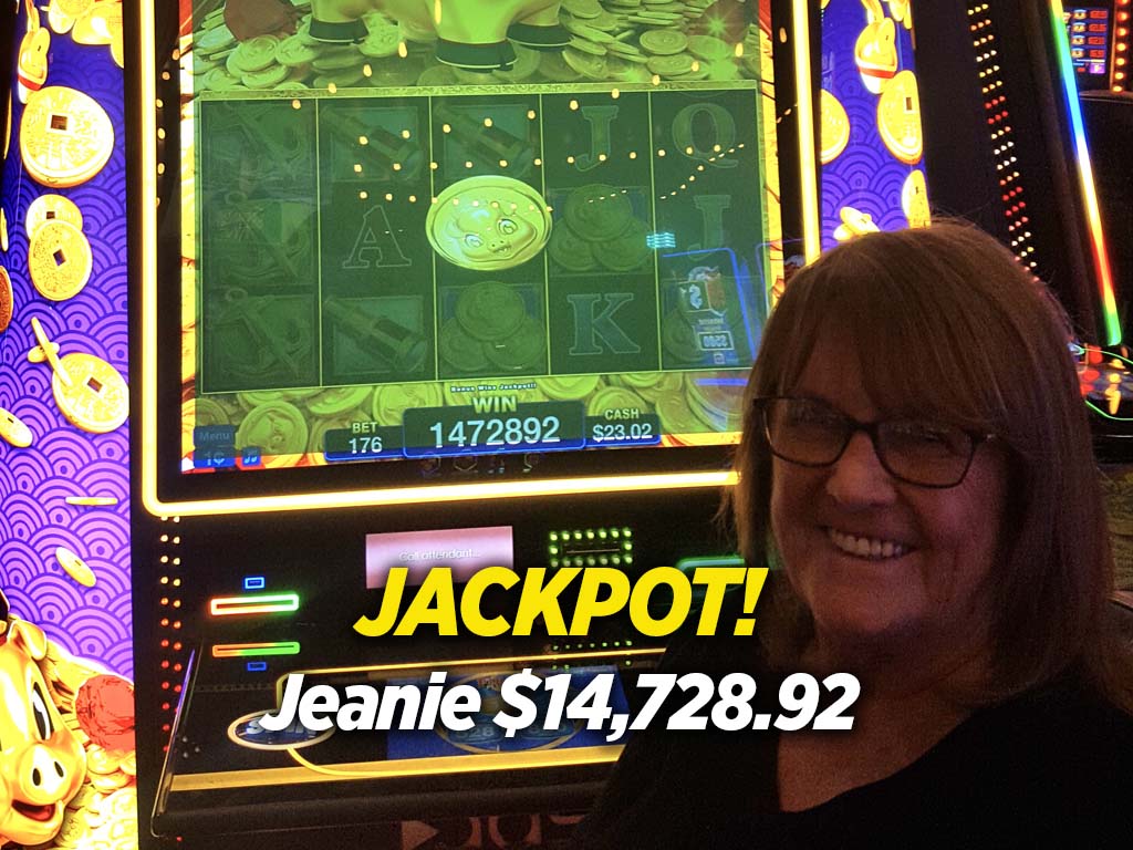 A woman standing in front of a slot machine with the words jackpot.