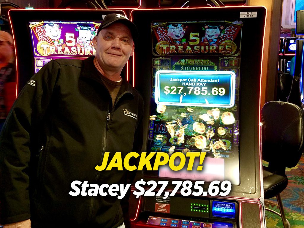 A man standing in front of a slot machine with the word jackpot.