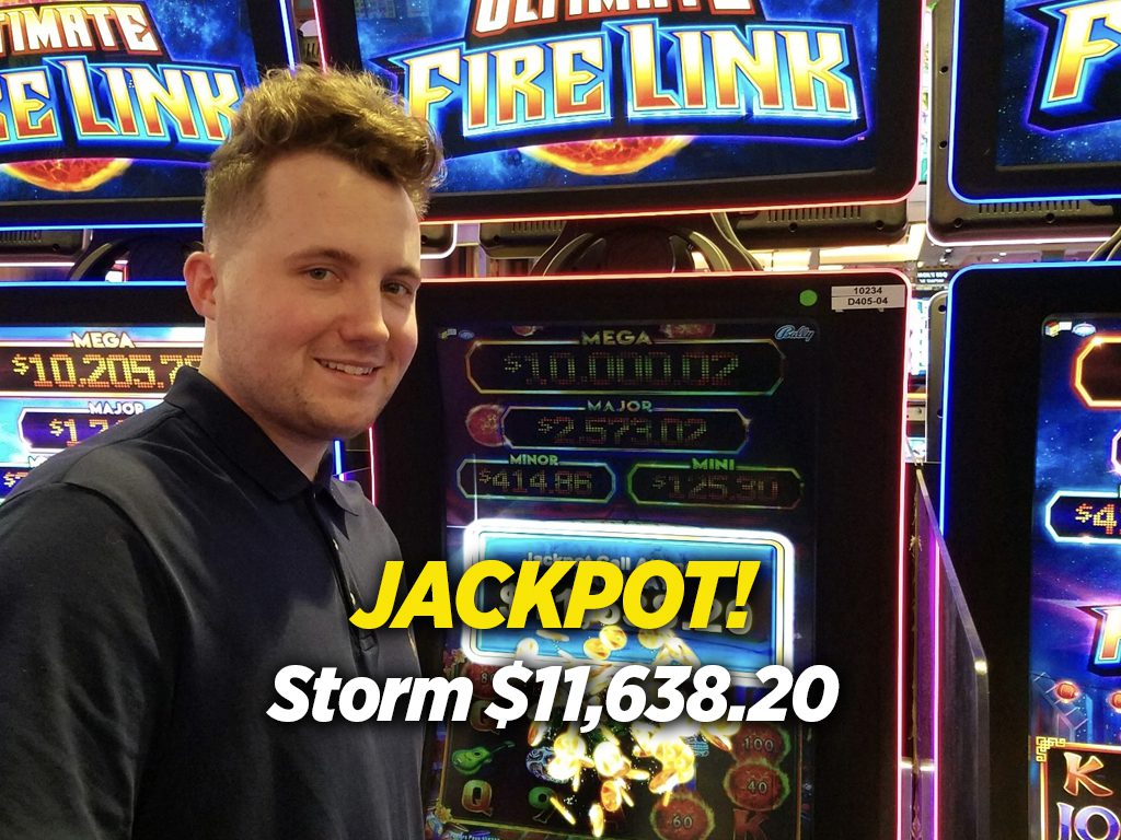 A man standing in front of a slot machine with the words jackpot storm.
