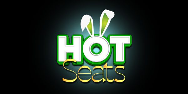 Logo with the words "HOT Seats" in bold letters, featuring bunny ears above the "O" in "HOT" against a dark background.