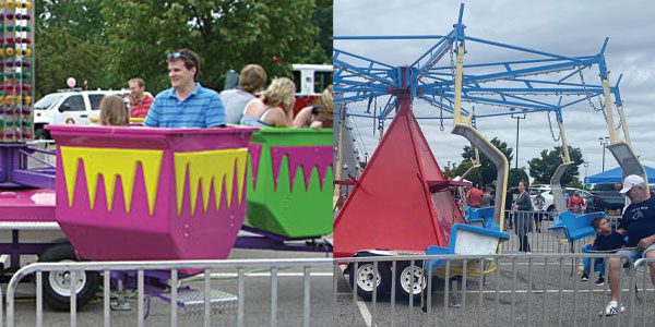 A man standing next to a carnival ride.