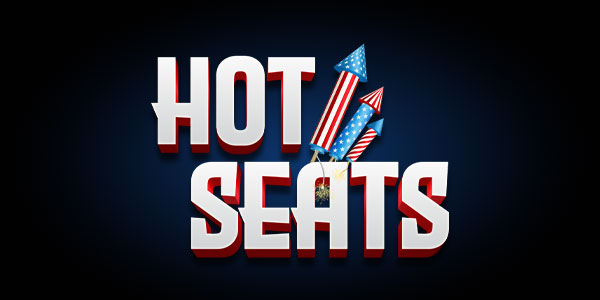 The words "HOT SEATS" in bold letters with three red, white, and blue firework rockets in the background on a dark blue gradient.
