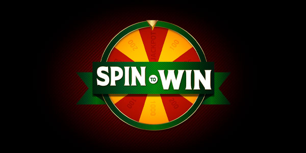 A colorful spinning prize wheel with "Spin to Win" written across the center on a green banner, set against a dark background.