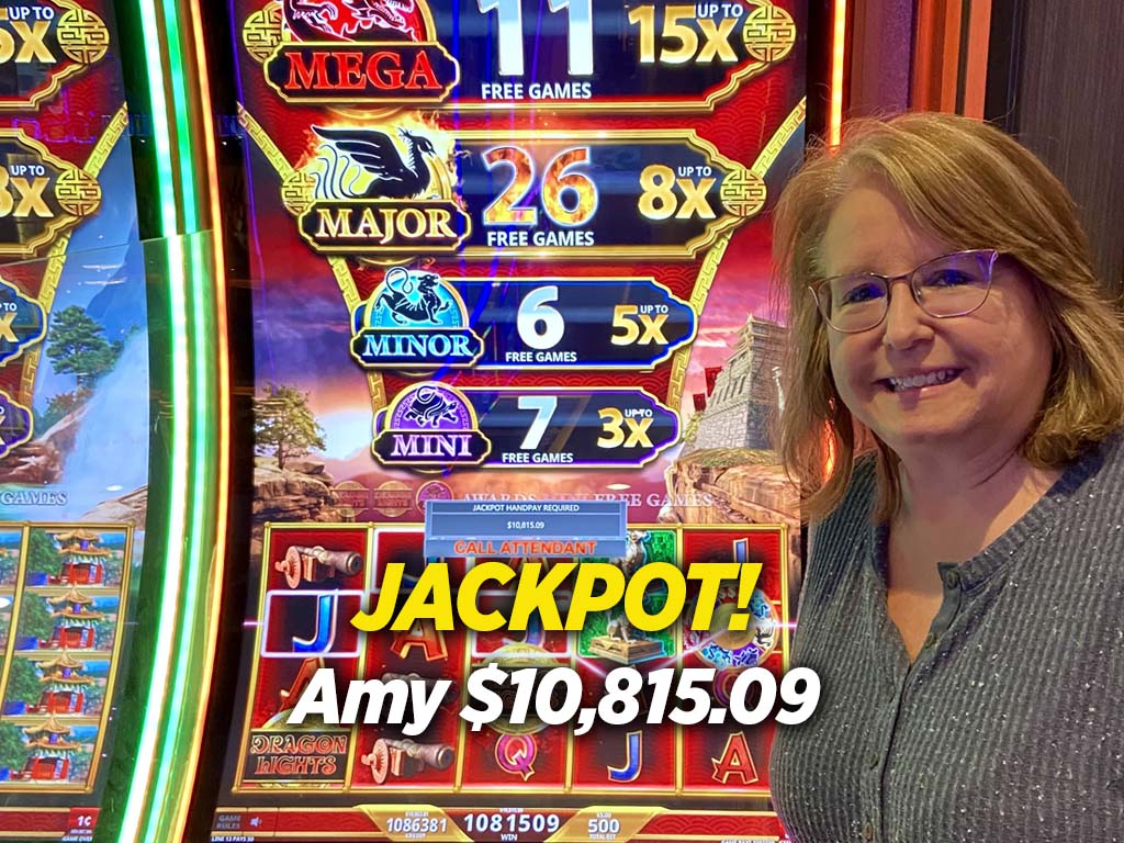 A woman standing in front of a slot machine.