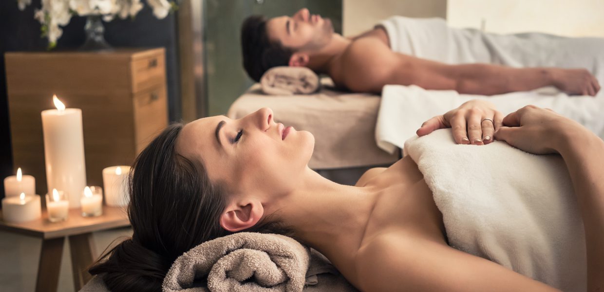 A man and woman having a massage in a spa.