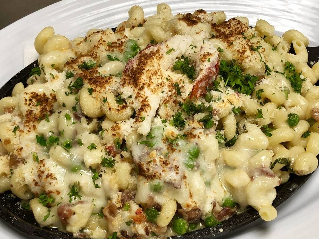 A plate of macaroni and cheese with broccoli.