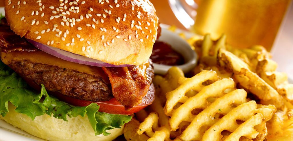 A hamburger and fries are on the table.